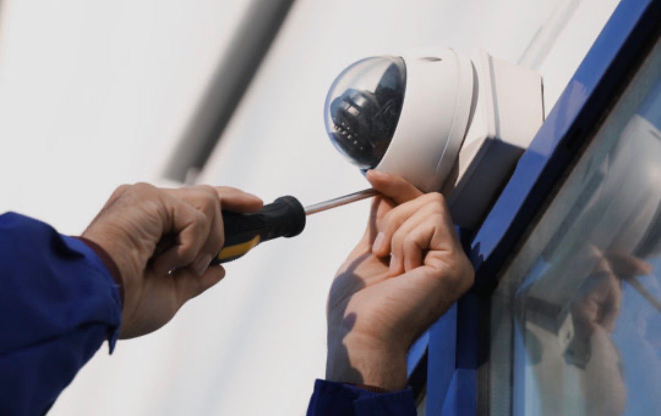 Engineer servicing a dome CCTV camera